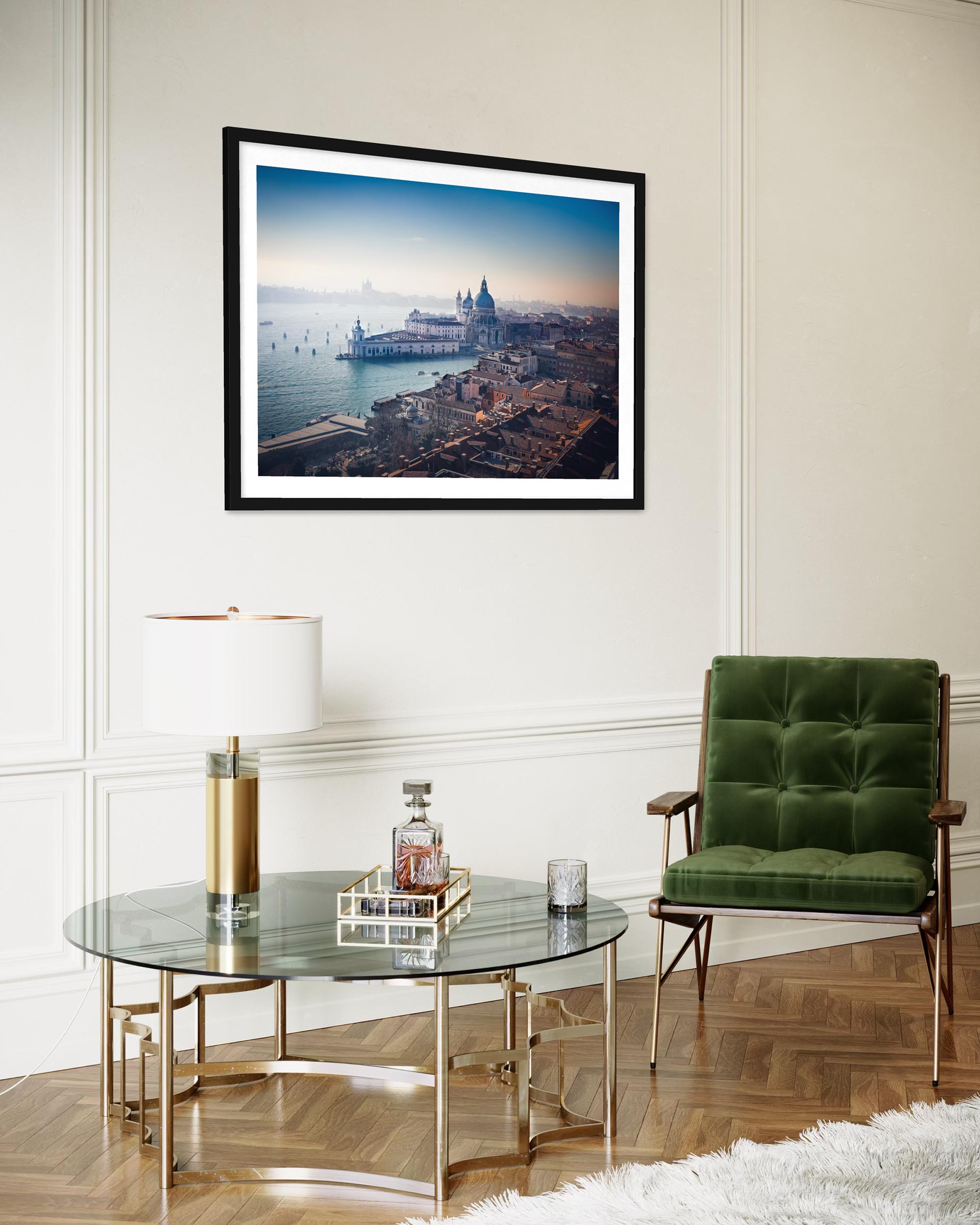 Modern living room with a framed cityscape, glass coffee table, and green armchair.