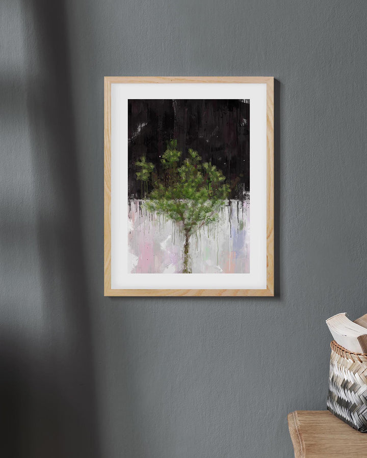 Framed artwork of a tree on a gray wall with a basket on a chair below.