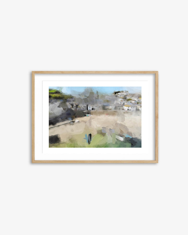 Framed artwork of a coastal village scene on a white wall