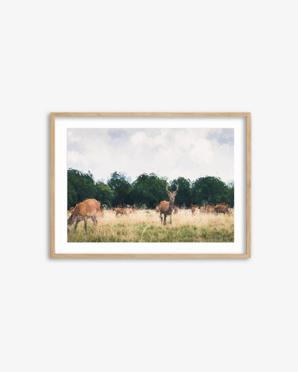 Framed print of deer in a field with trees and blue sky.