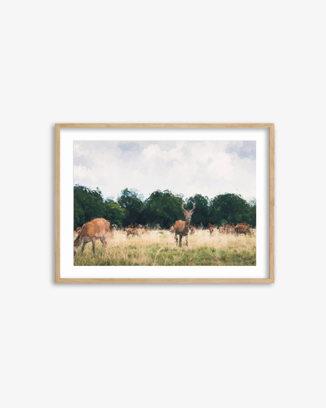 Framed print of deer in a field with trees and blue sky.