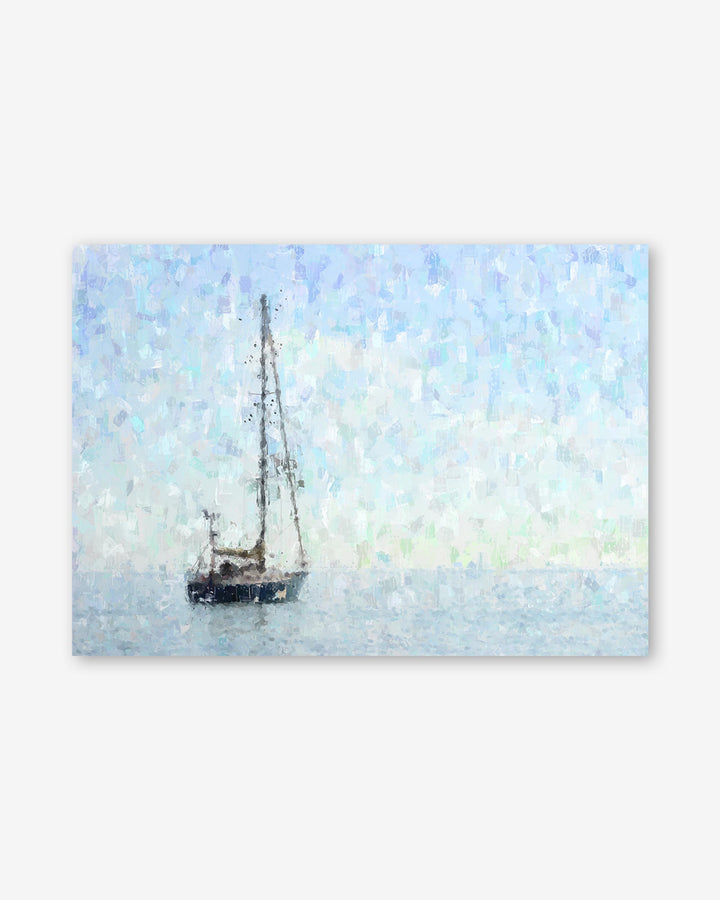 Sailboat on water with a light blue sky