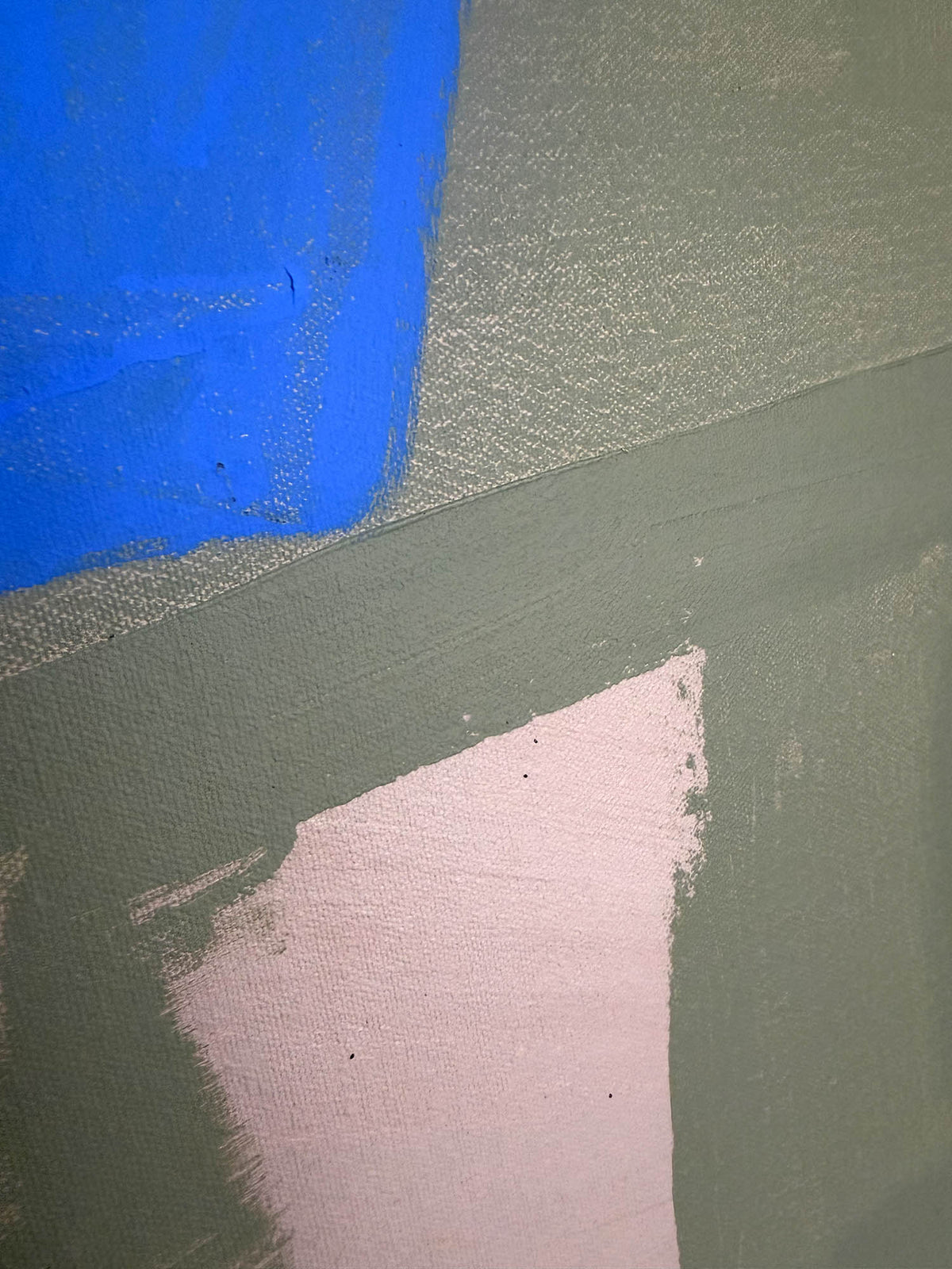 Abstract painted canvas with geometric color blocks in blue, gray, sage green, and pale pink, showing visible canvas texture and brushstrokes.