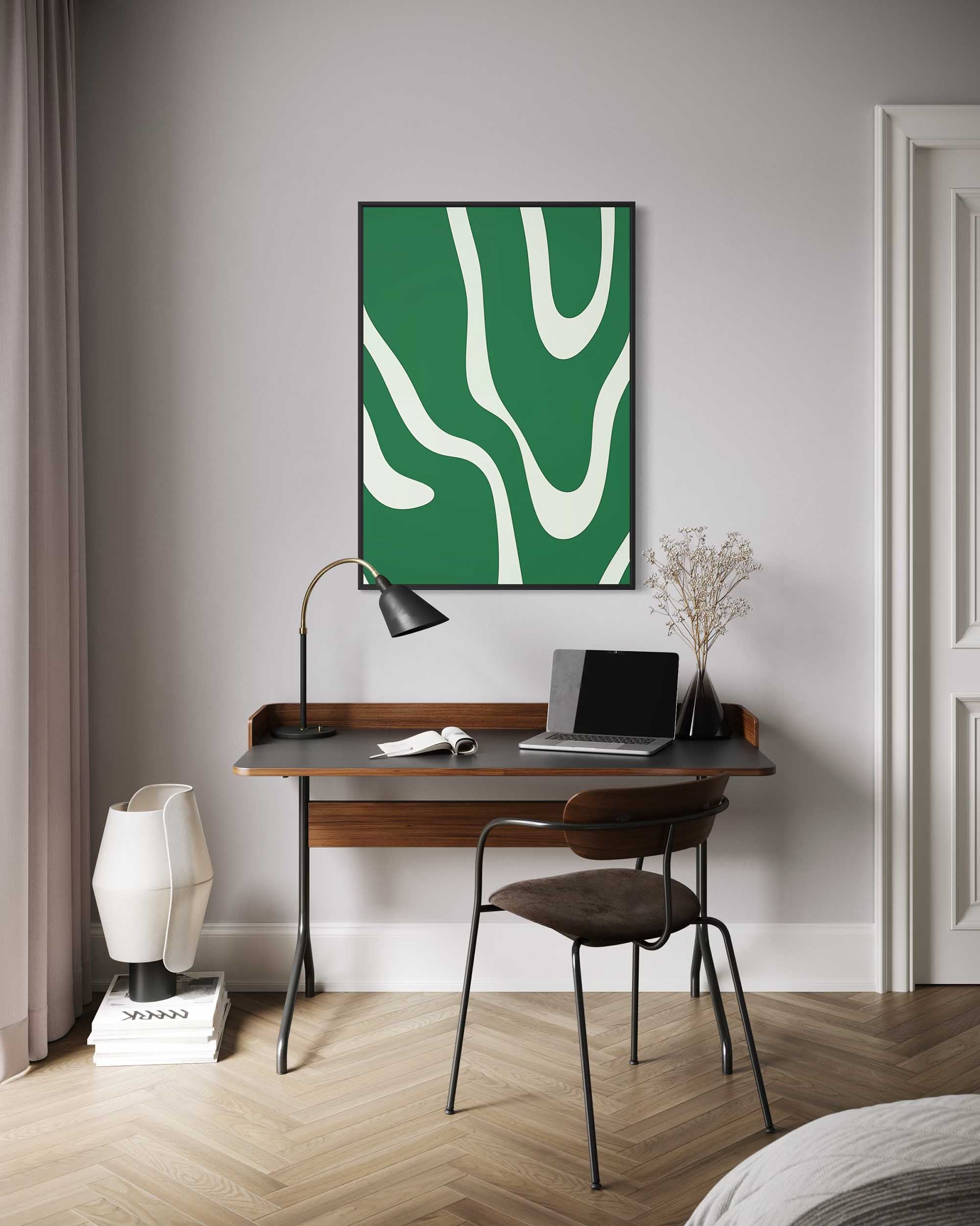 Modern home office with a wooden desk, chair, lamp, and abstract green artwork on the wall.
