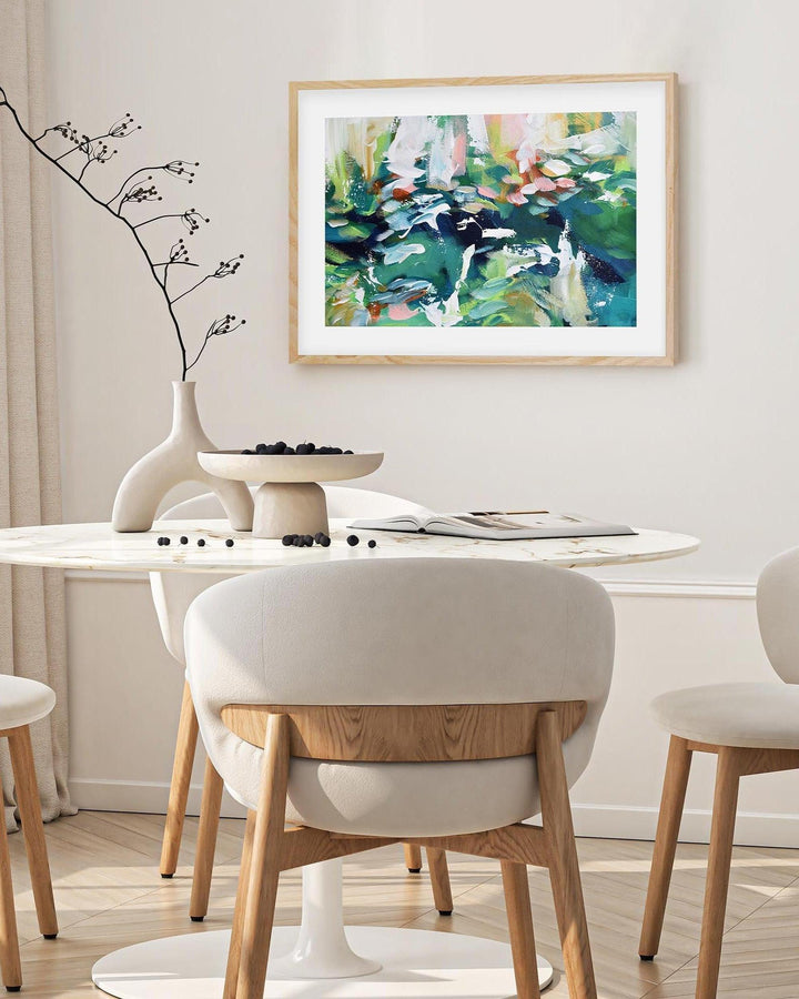 Modern dining room with round table and chairs, abstract painting on the wall.
