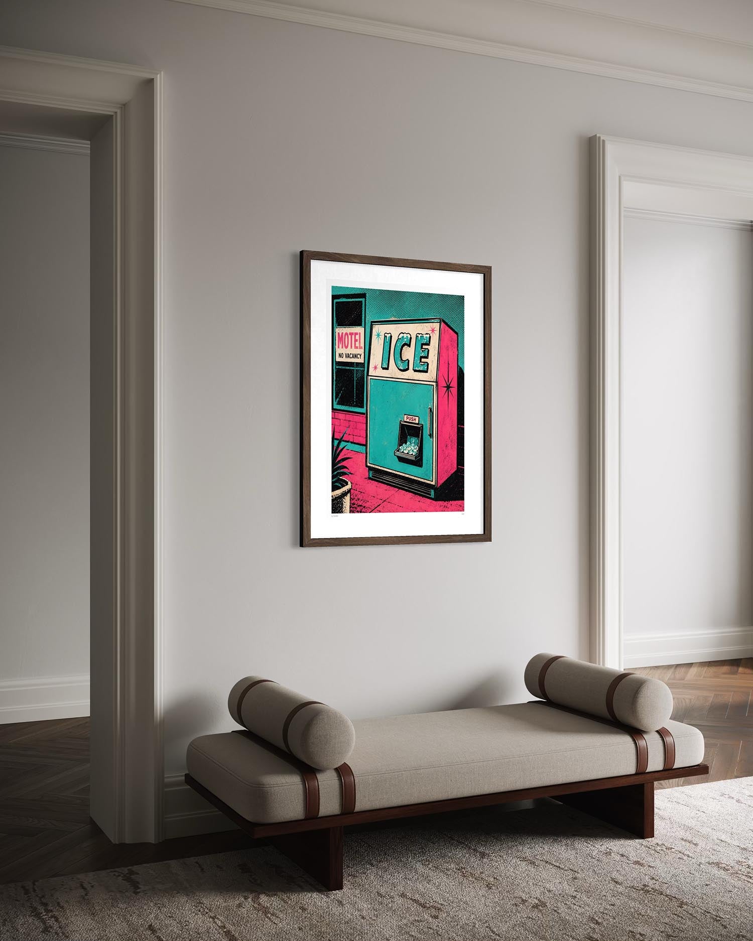 A framed art print of a retro ice machine poster hangs on a light gray wall in a modern room setting above a beige bench.