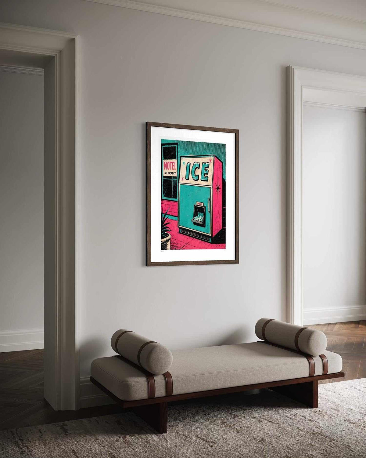 A framed art print of a retro ice machine poster hangs on a light gray wall in a modern room setting above a beige bench.