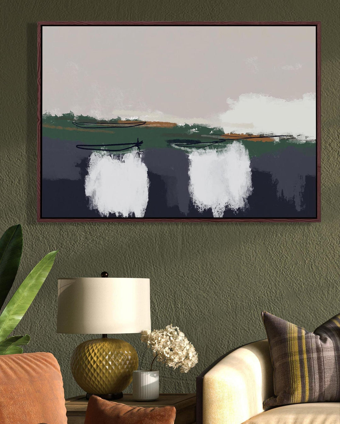 Framed artwork of a landscape with boats on a wall in a living room.