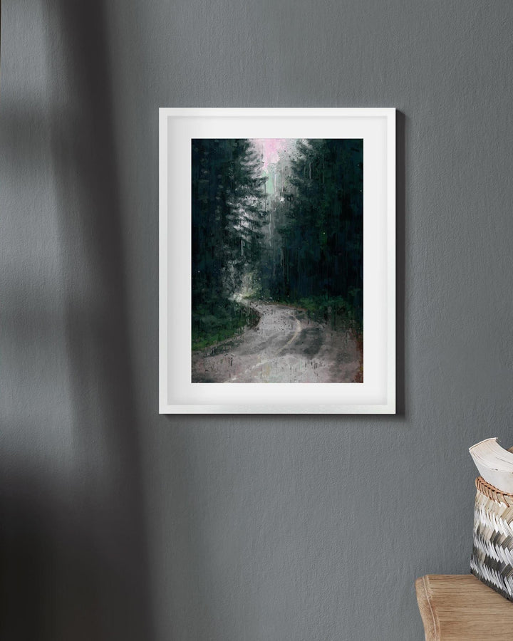 Framed print of a forest scene on a gray wall with a basket and pillow in the corner.