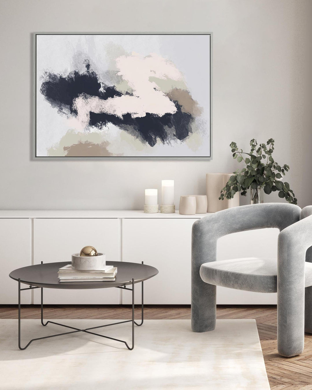 Modern living room with abstract art, coffee table, and gray chairs.