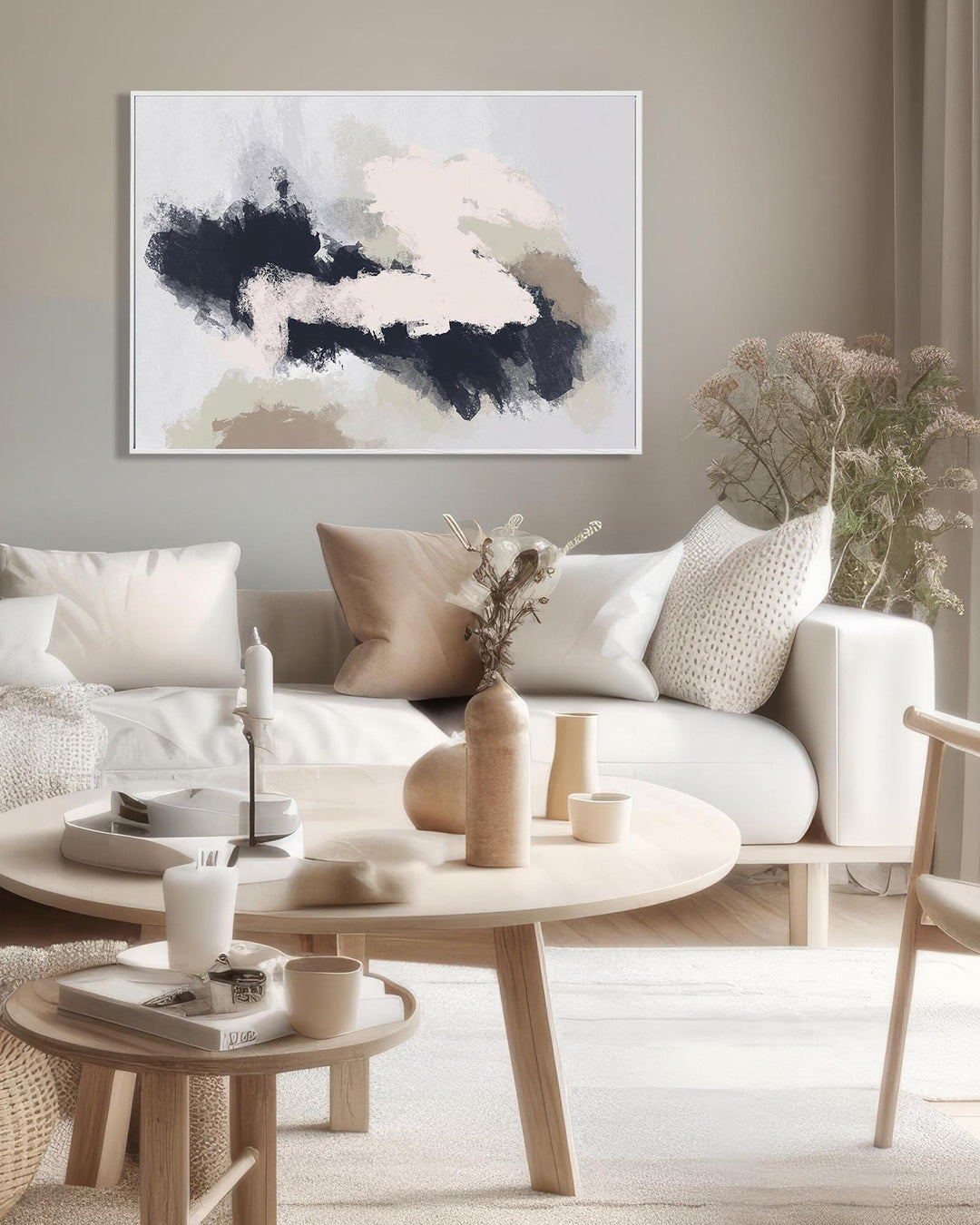 Modern living room with a white sofa, wooden coffee table, and abstract art on the wall.