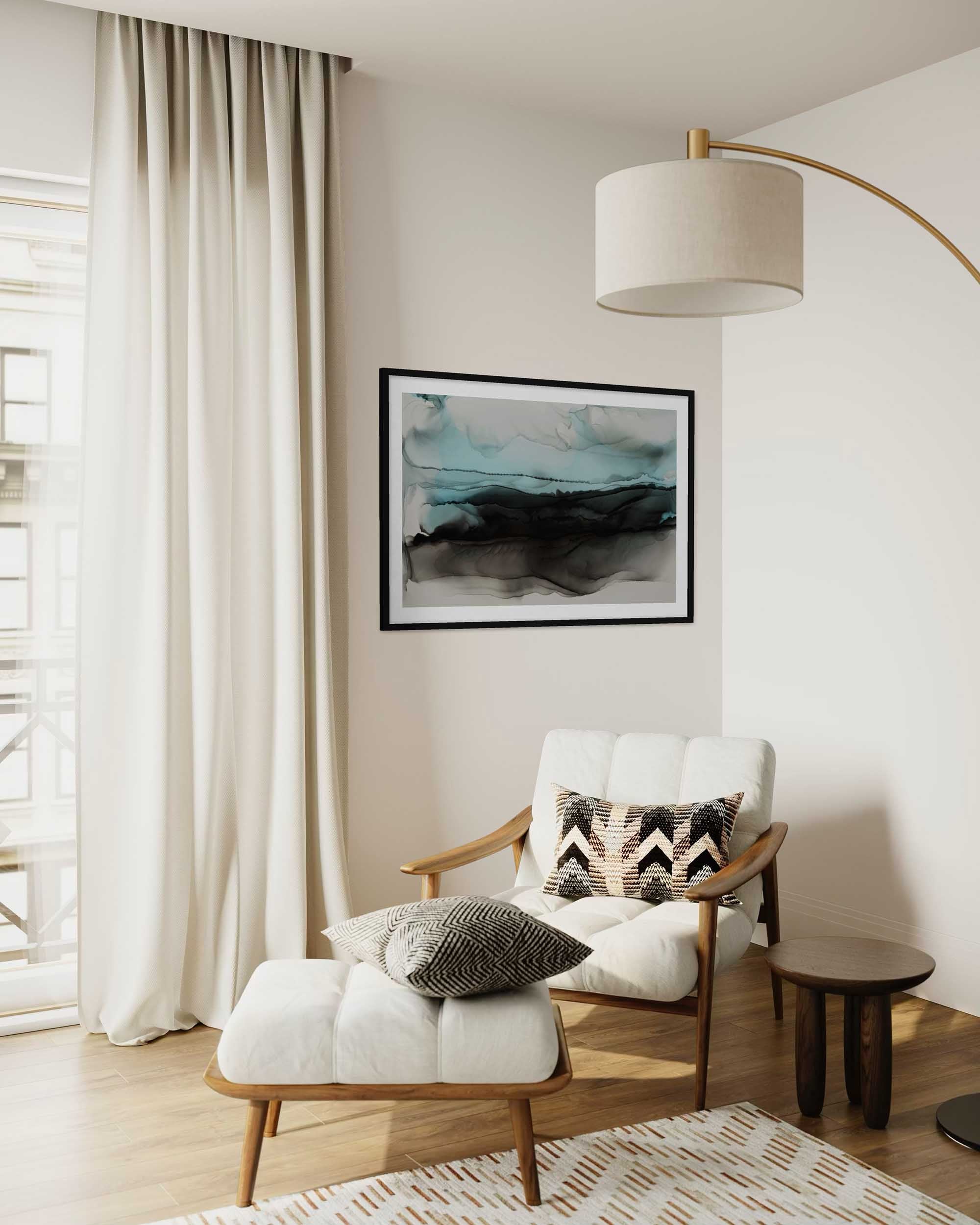 Modern living room with a white armchair, ottoman, and abstract art on the wall.