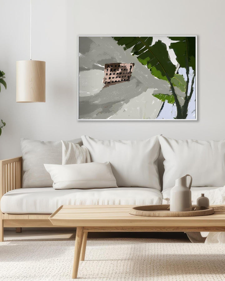 Modern living room with a white sofa, wooden coffee table, and abstract art on the wall.