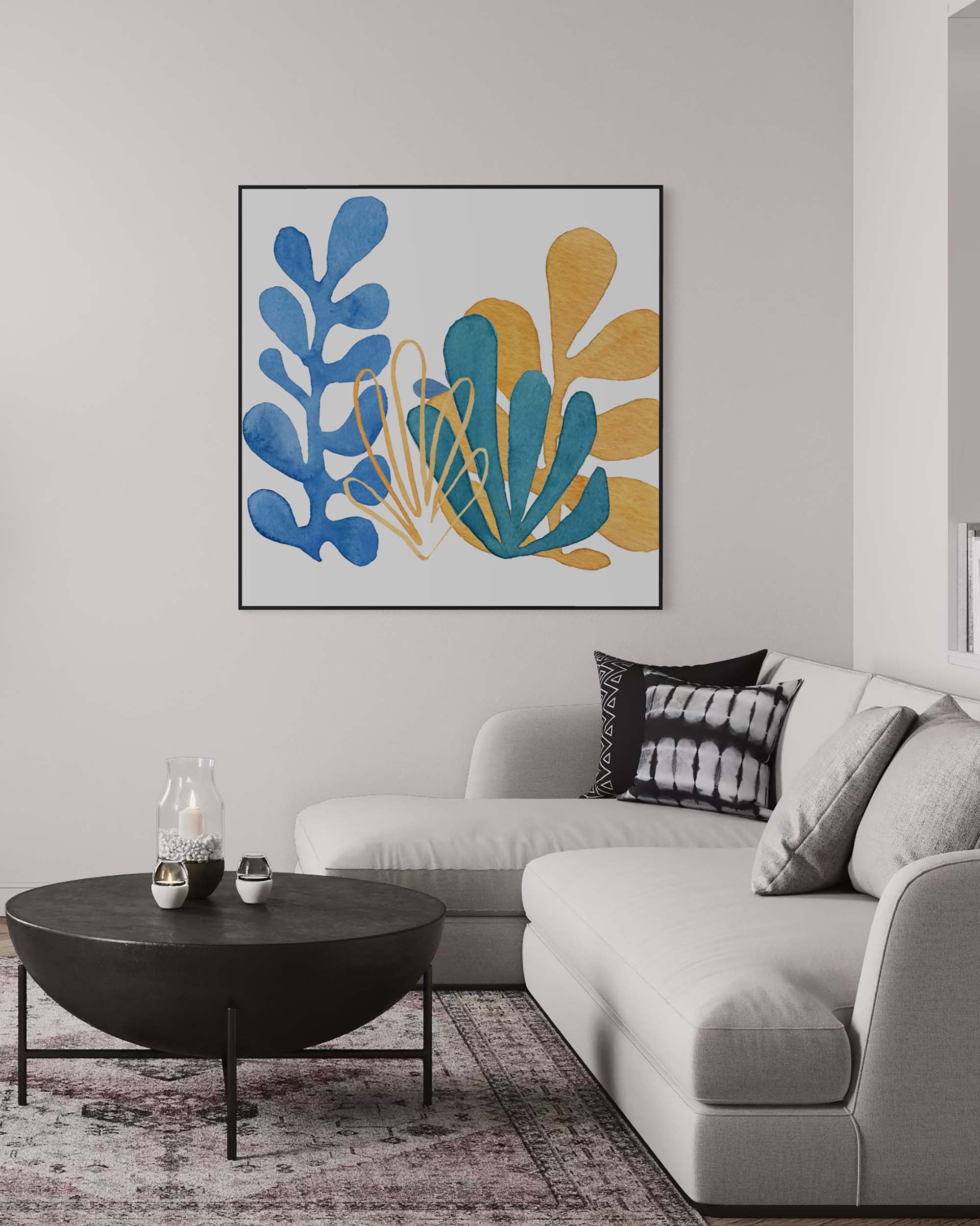 Modern living room with a gray sofa, round black coffee table, and abstract art on the wall.