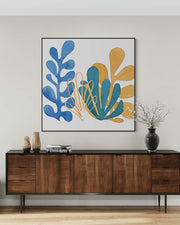 Wooden sideboard with decorative items and a colorful abstract painting on a wall.