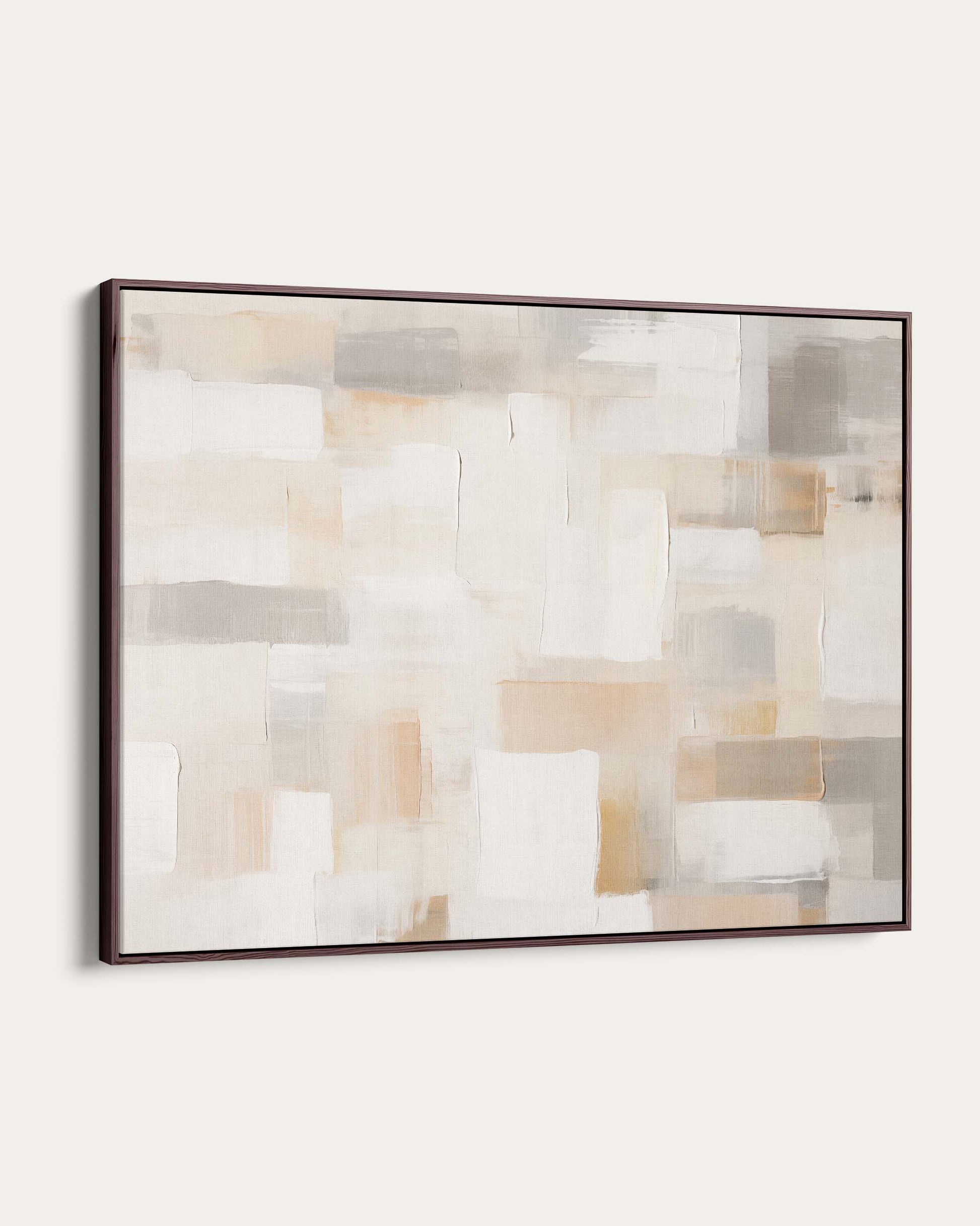 Abstract art piece with geometric shapes in neutral colors on a white wall