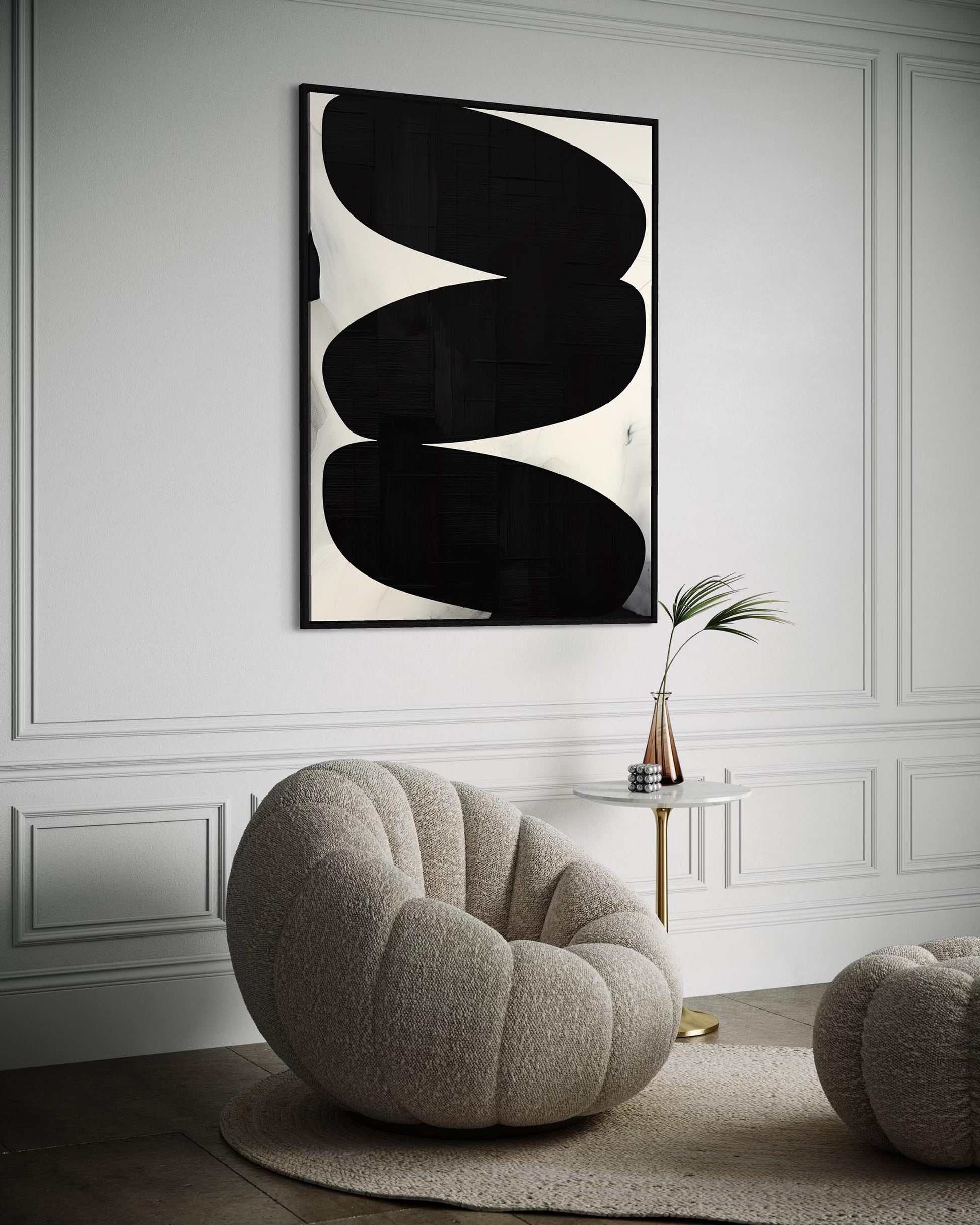 Modern interior with abstract art and a textured chair.