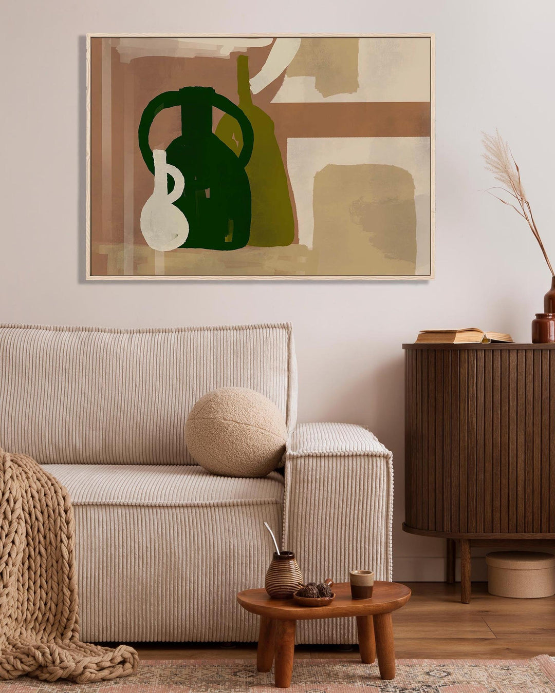 Living room with beige sofa, wooden side table, and abstract art on the wall.