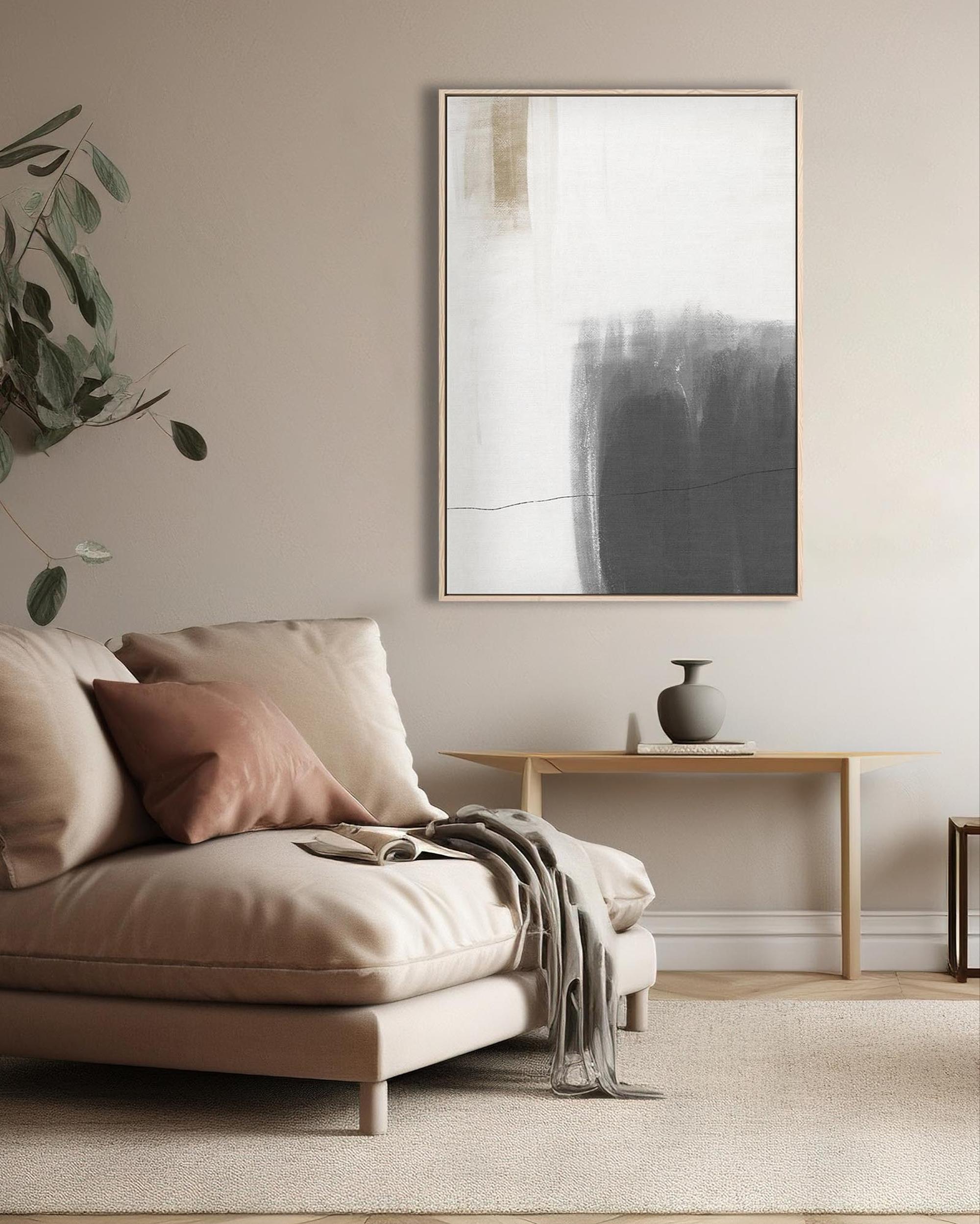 Living room with a beige sofa, abstract painting, and side table.