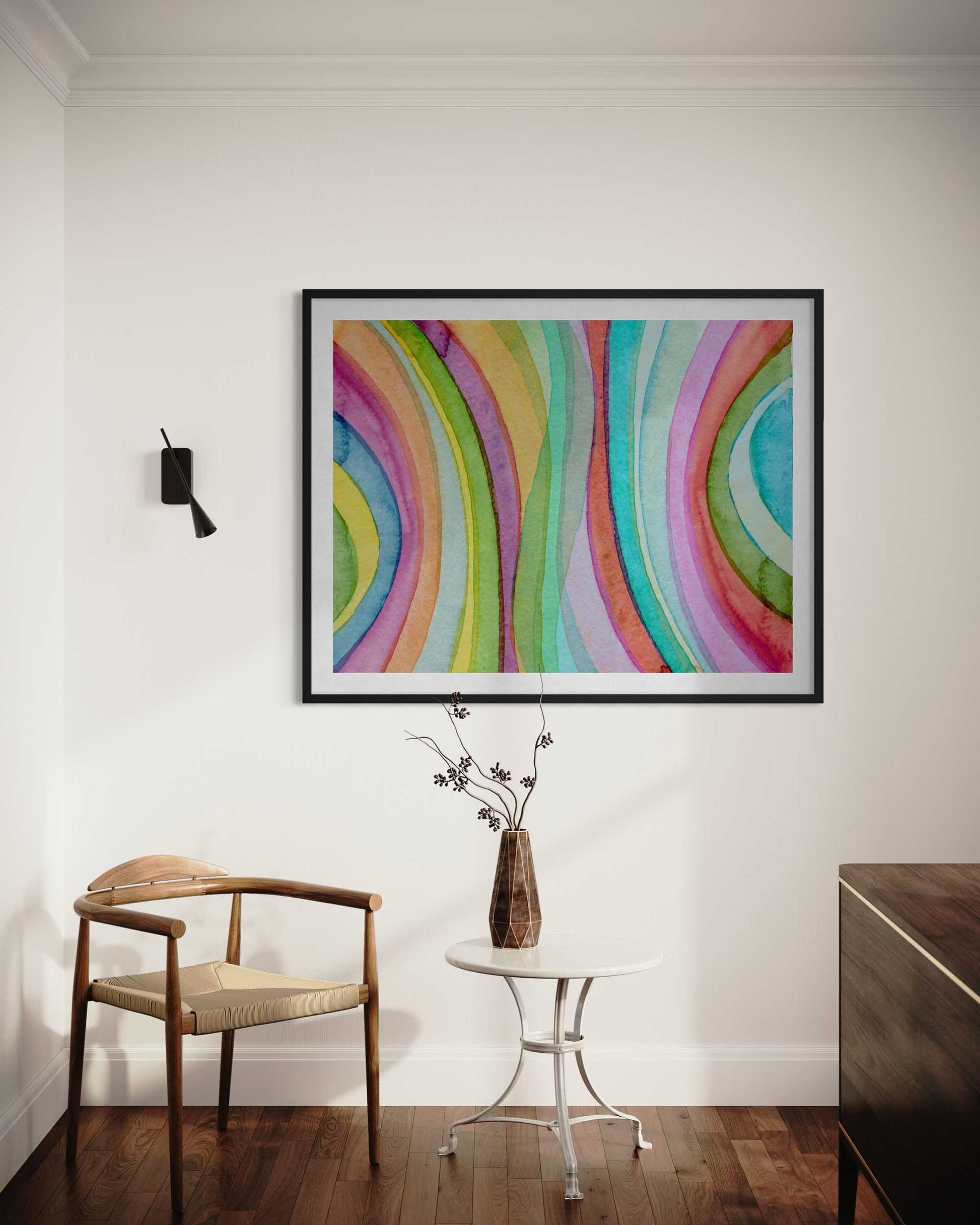 Colorful abstract painting on a wall above a wooden chair and small table.