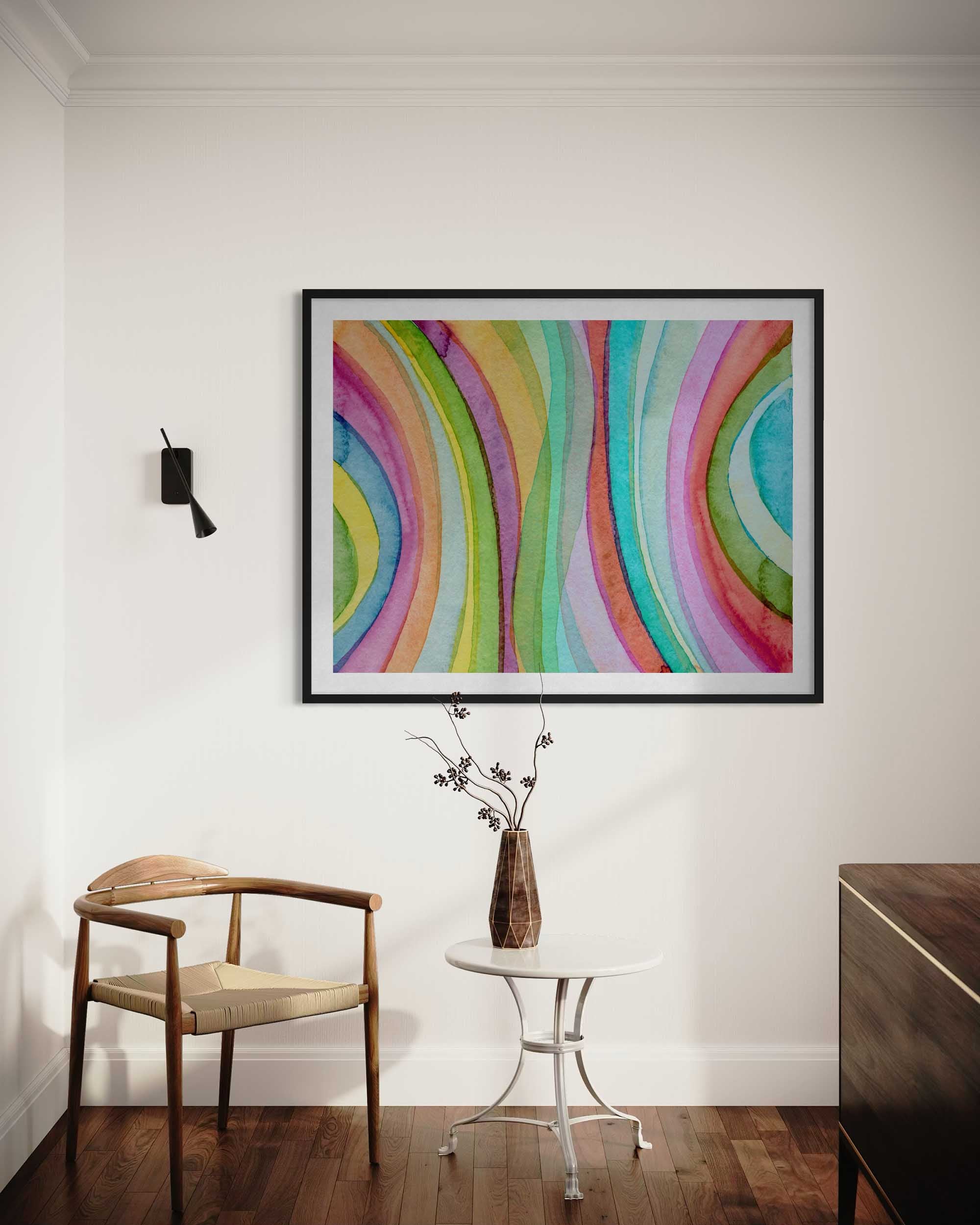 Colorful abstract painting on a wall above a wooden chair and small table.