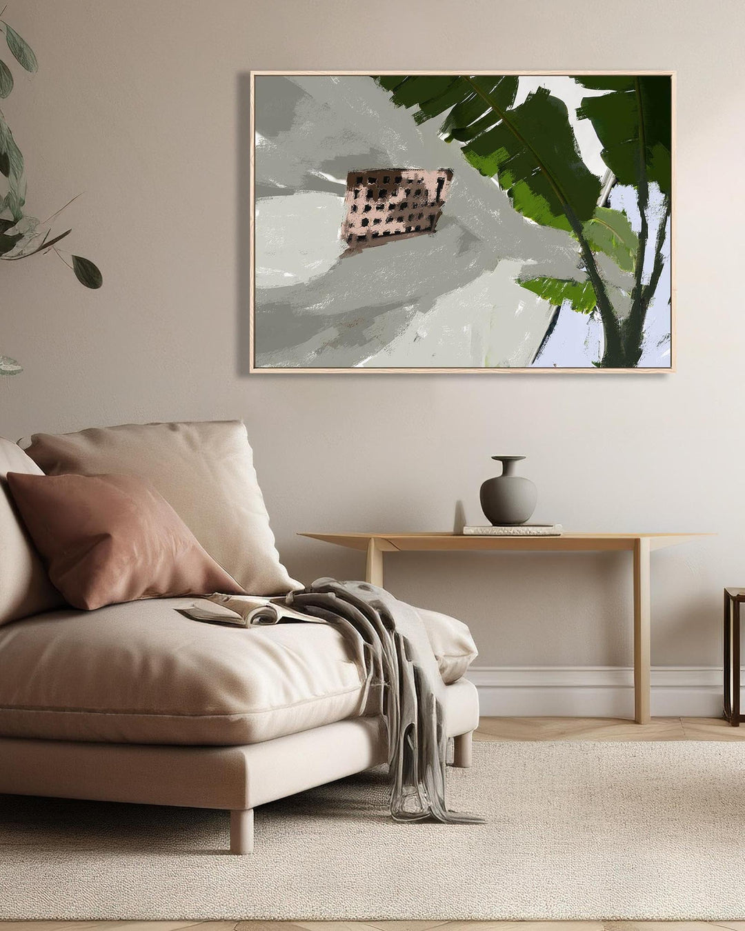 Modern living room with beige sofa, decorative pillows, and a framed abstract art piece.