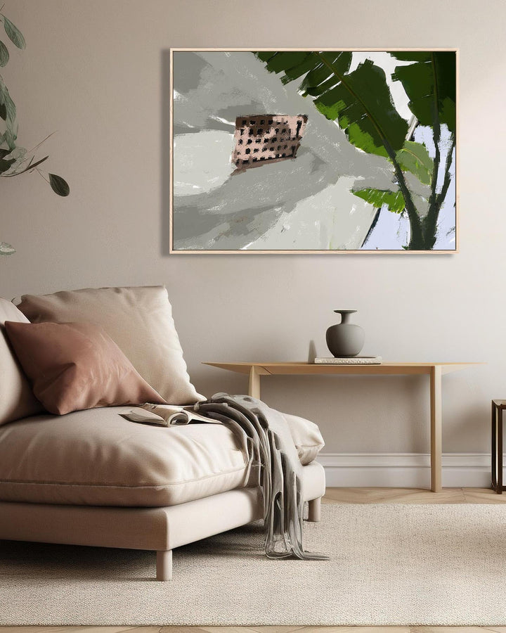 Modern living room with beige sofa, decorative pillows, and a framed abstract art piece.