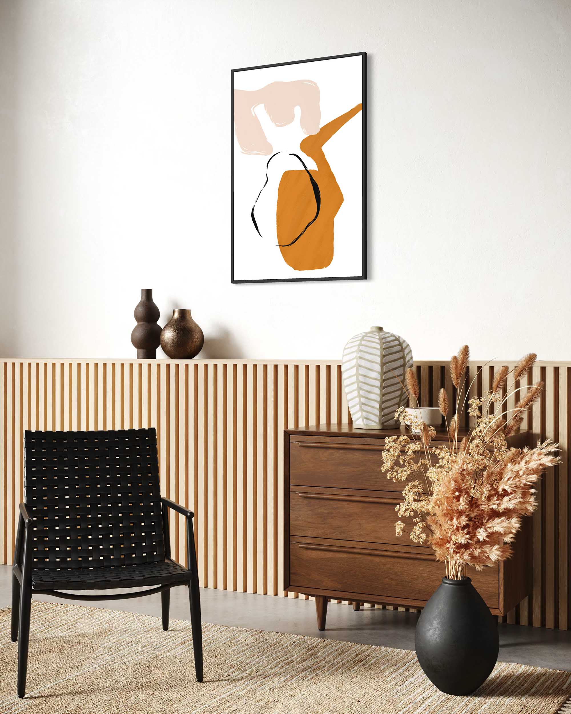 Modern interior with a black chair, wooden dresser, and abstract art on the wall.