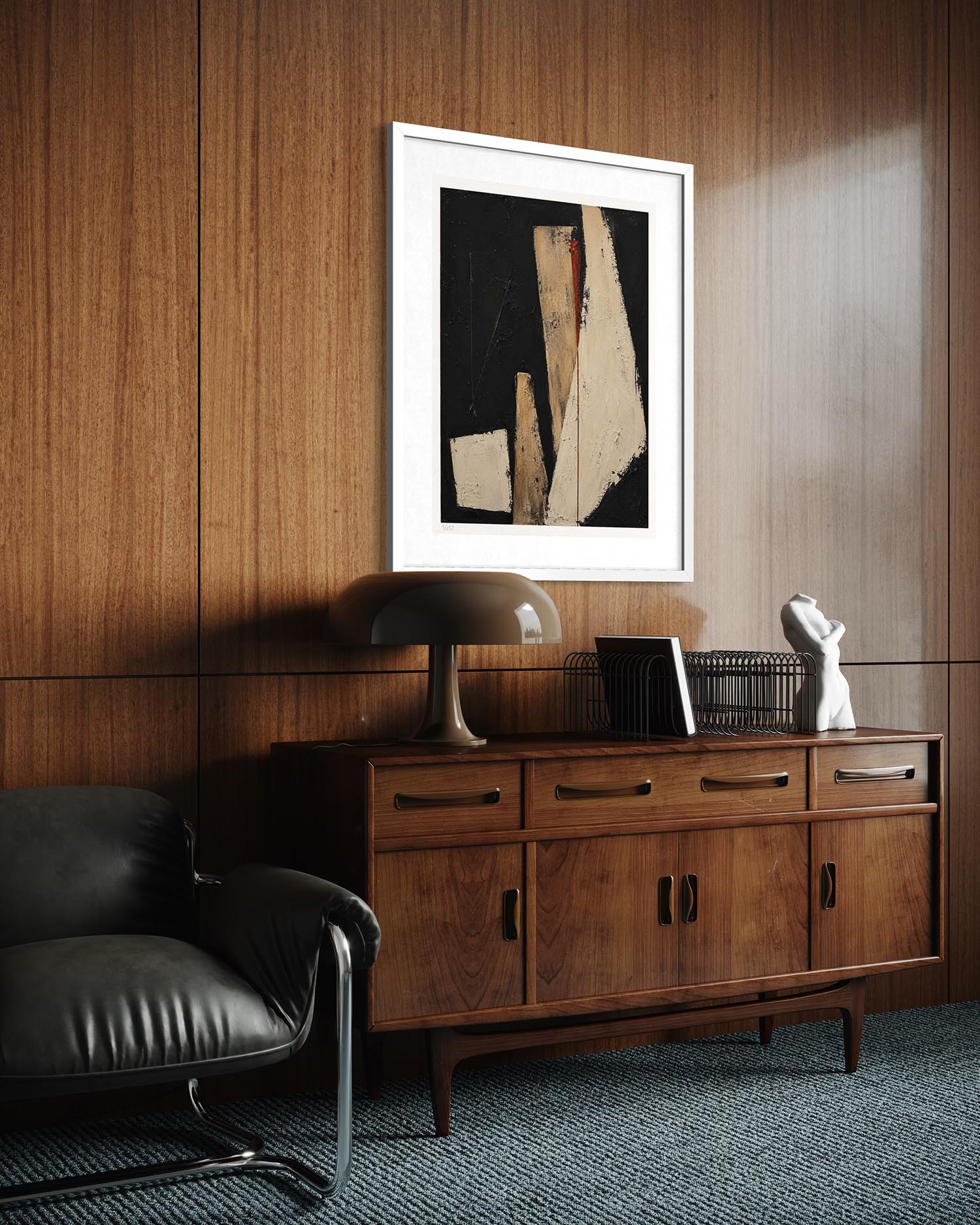 A framed abstract art print with black, beige, and white geometric shapes hangs on a wood-paneled wall above a mid-century modern wooden sideboard with a lamp and a small white sculpture.