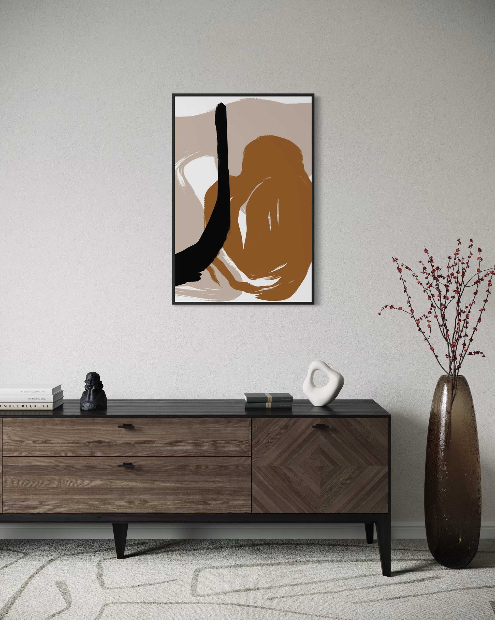 Abstract art print on a wall above a wooden console table with decorative items.