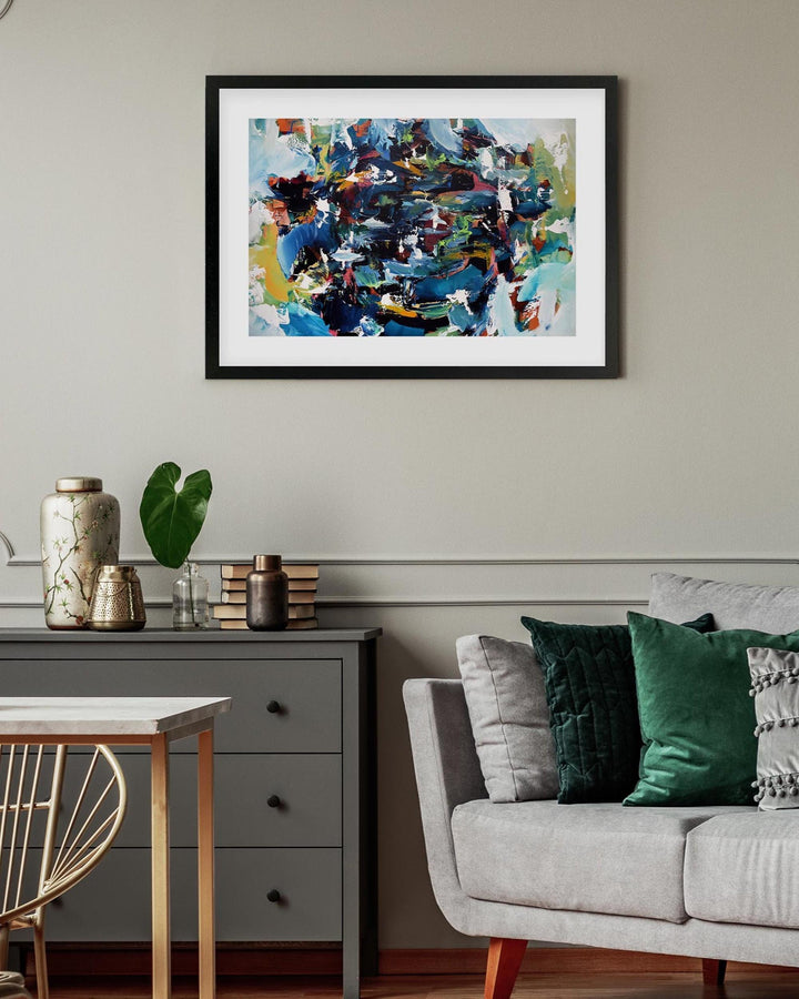 Living room with a colorful abstract painting on the wall, gray sofa, and side table.