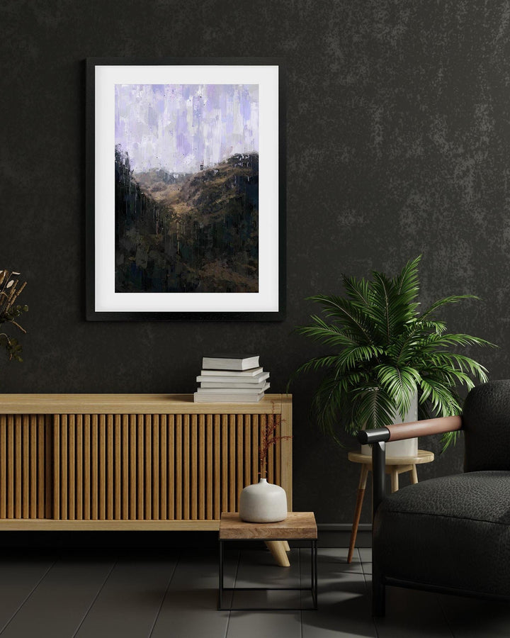 Framed abstract painting on a dark wall above a wooden console table with books and a plant.