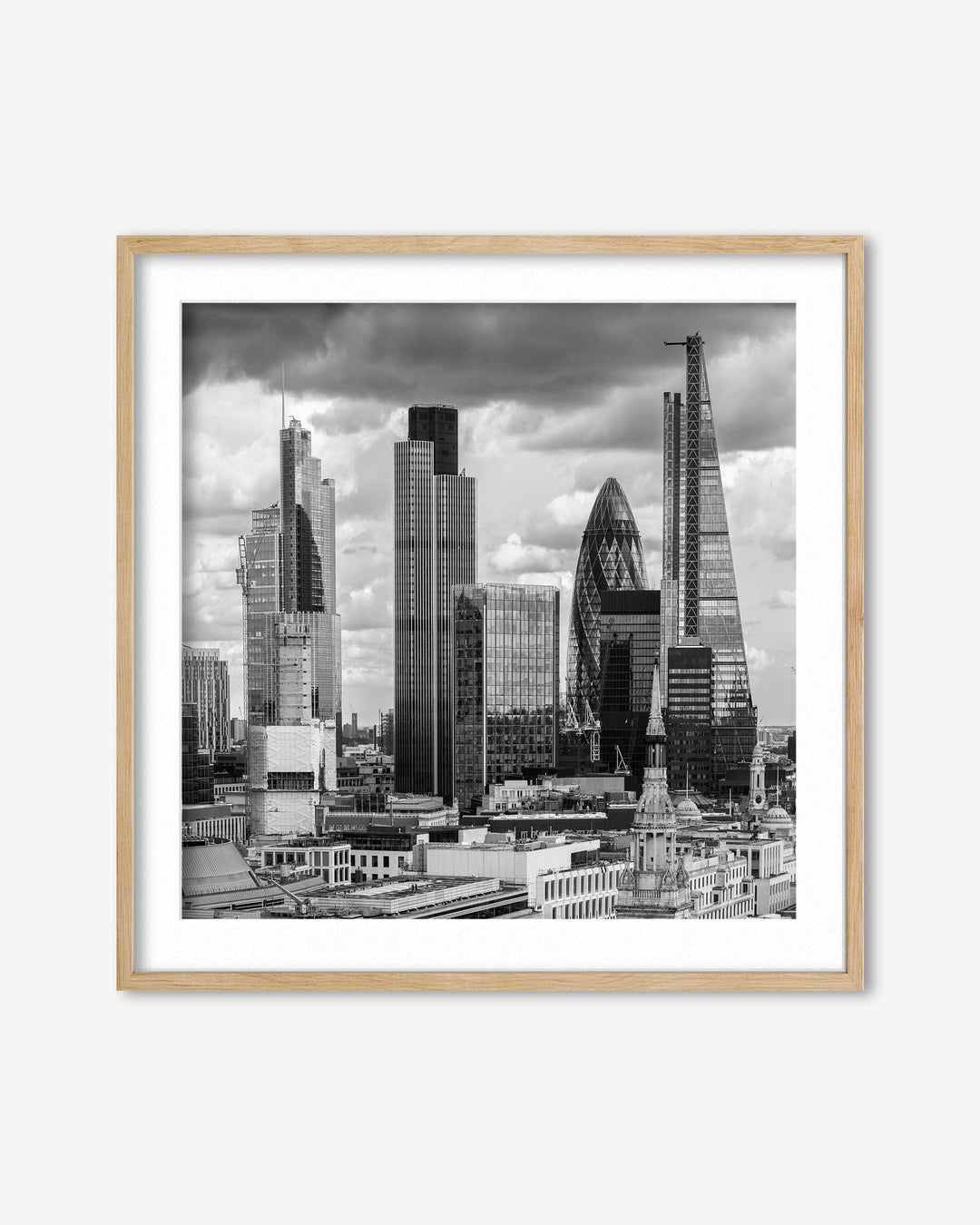 Framed black and white cityscape print of a skyline with modern buildings.