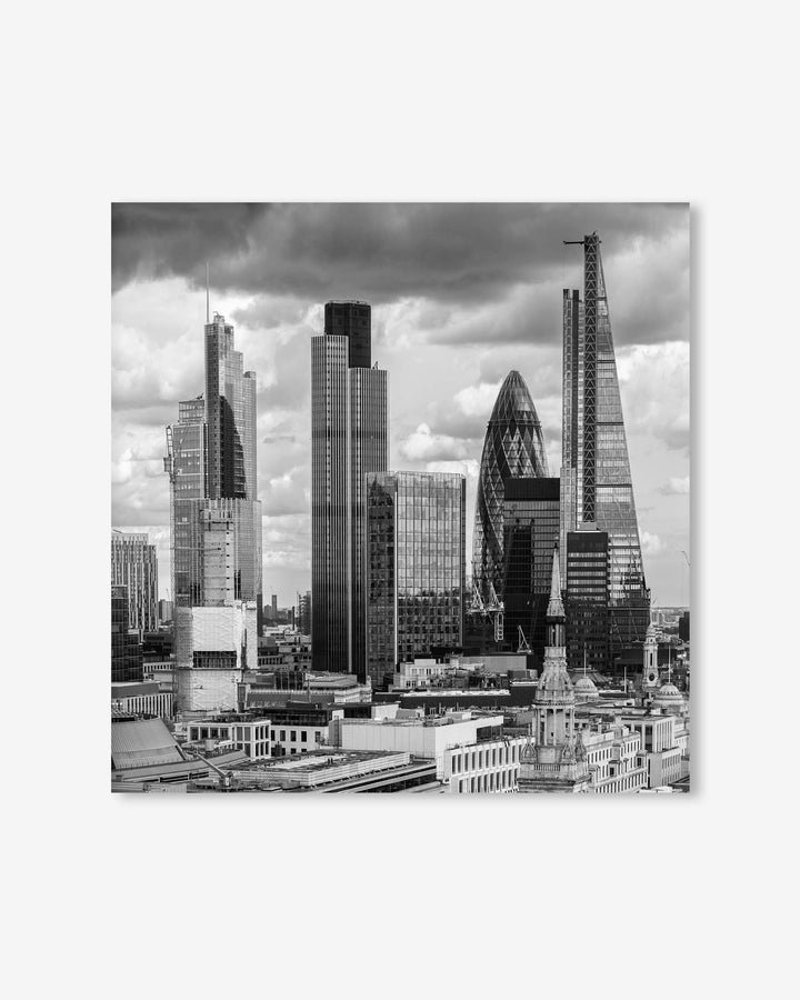 Black and white cityscape with modern skyscrapers under a cloudy sky