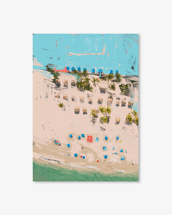 Aerial view of a beach with lounge chairs, umbrellas, and palm trees.