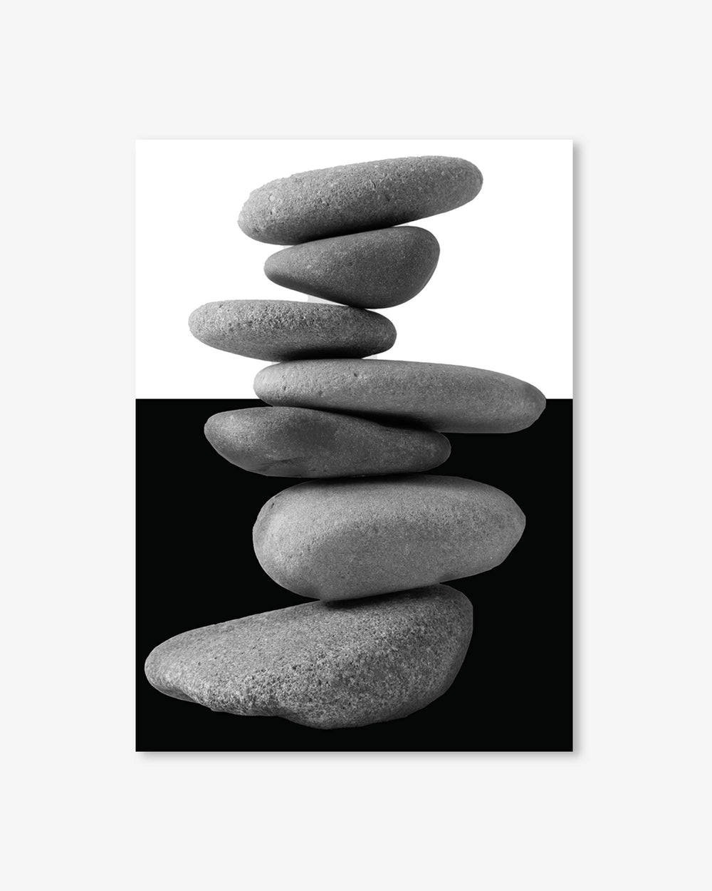 Stack of gray stones on a black and white background
