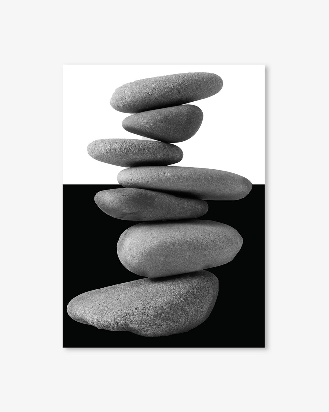 Stack of gray stones on a black and white background