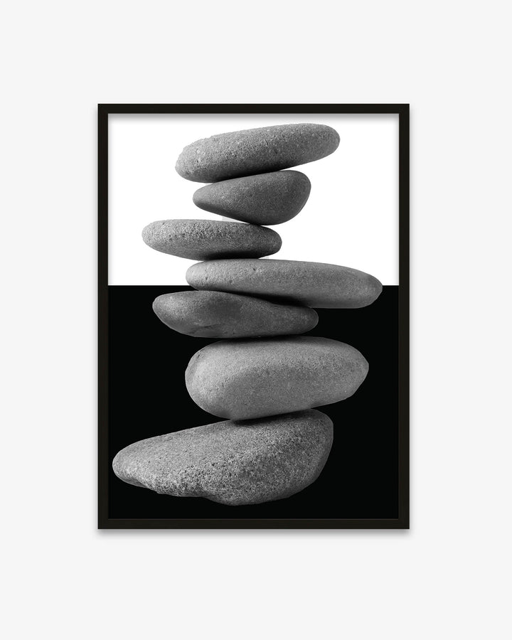 Framed artwork of stacked stones on a white background