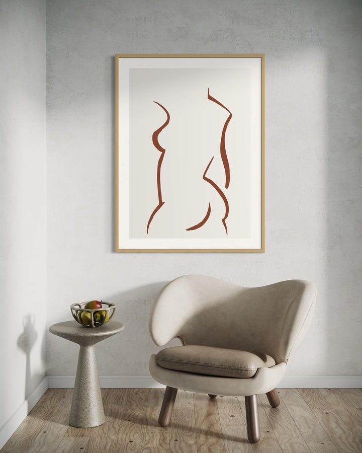 Framed abstract art on a wall above a modern chair and side table.