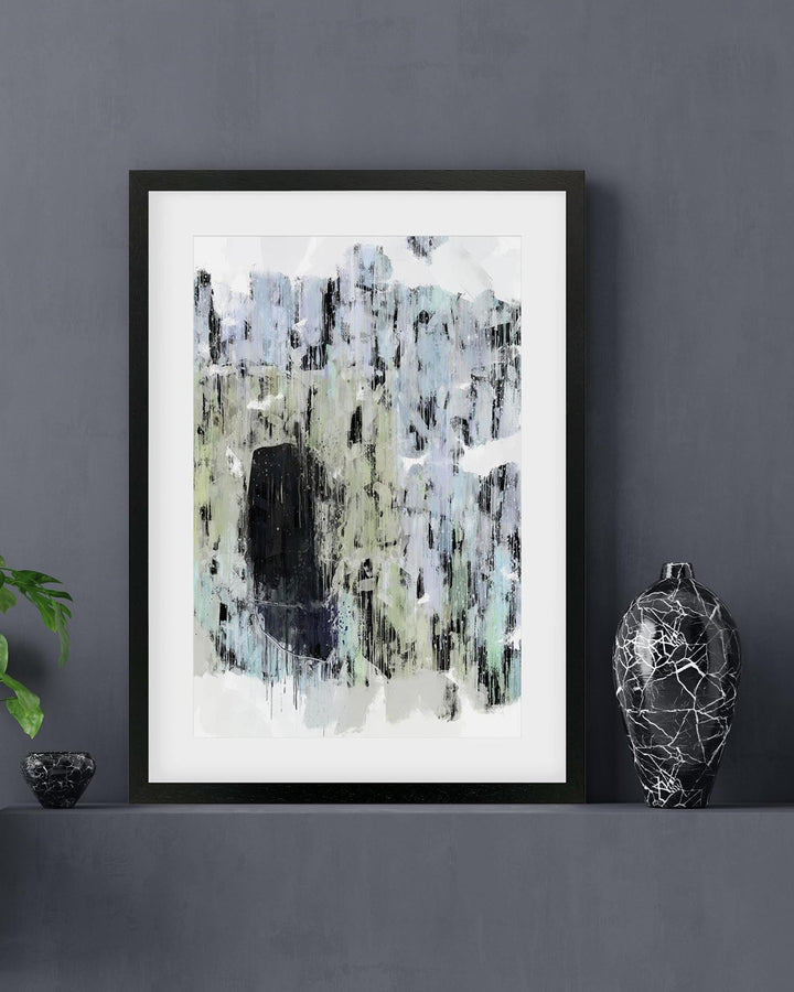 Framed abstract art print on a gray wall with decorative elements.