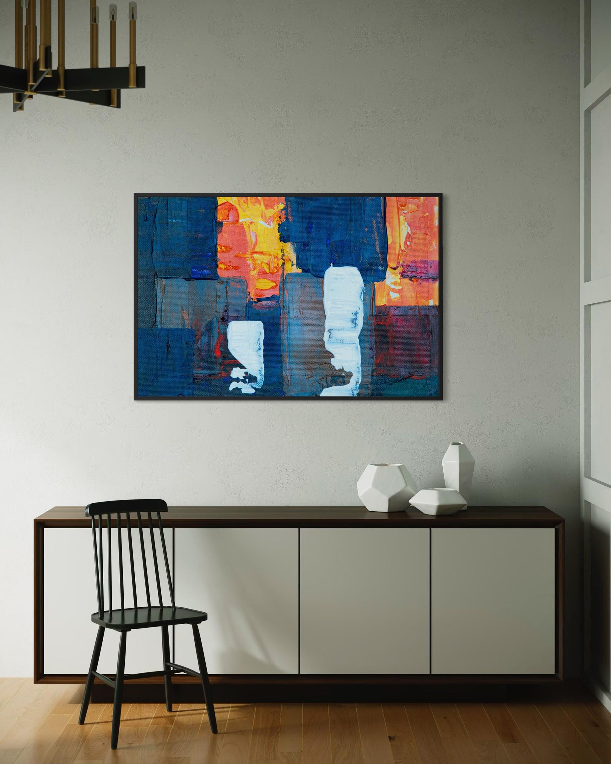 Abstract painting on a wall above a console table with a chair and decorative vases.