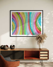 Colorful abstract art on a wall above a wooden console table with decorative items.