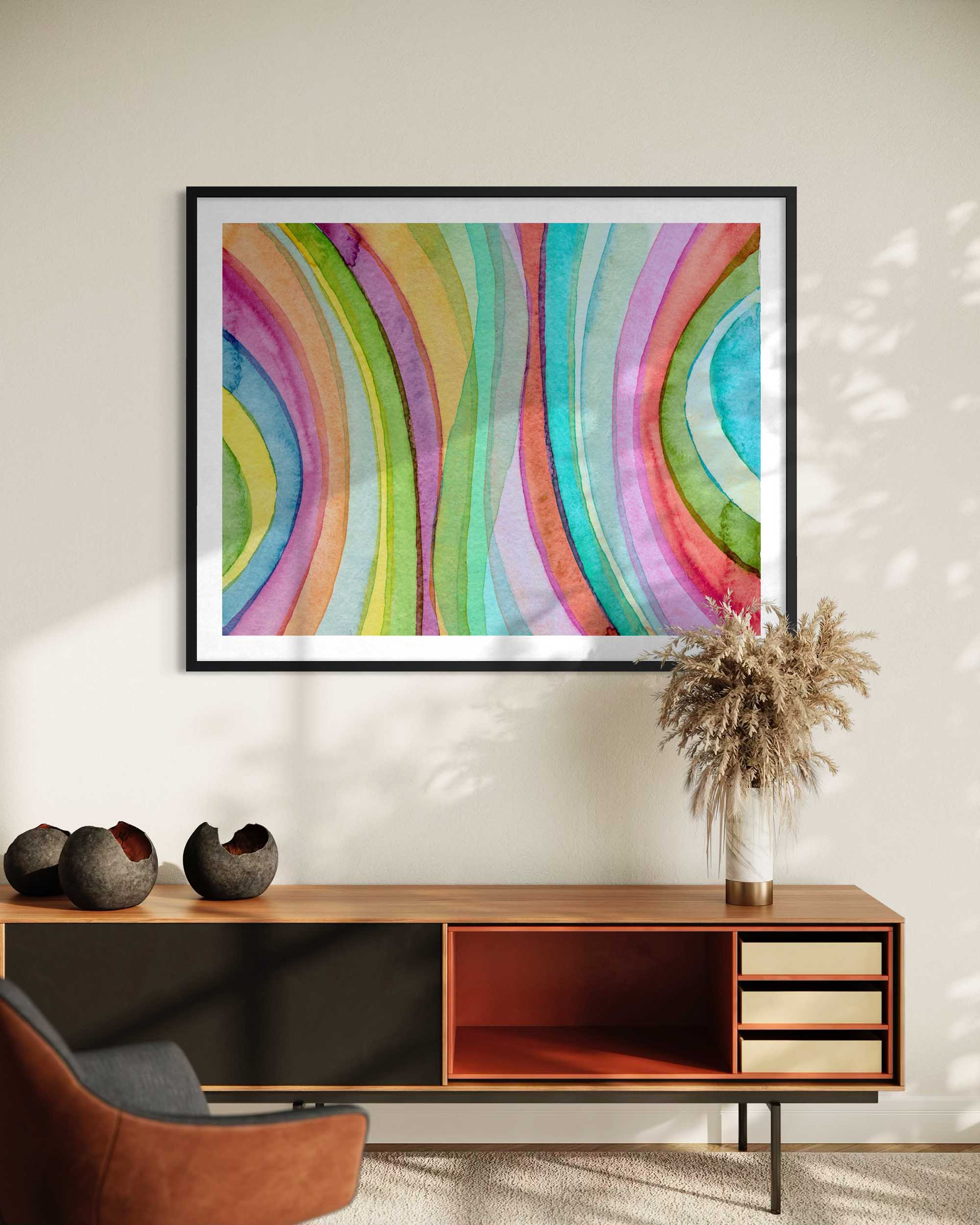 Colorful abstract art on a wall above a wooden console table with decorative items.