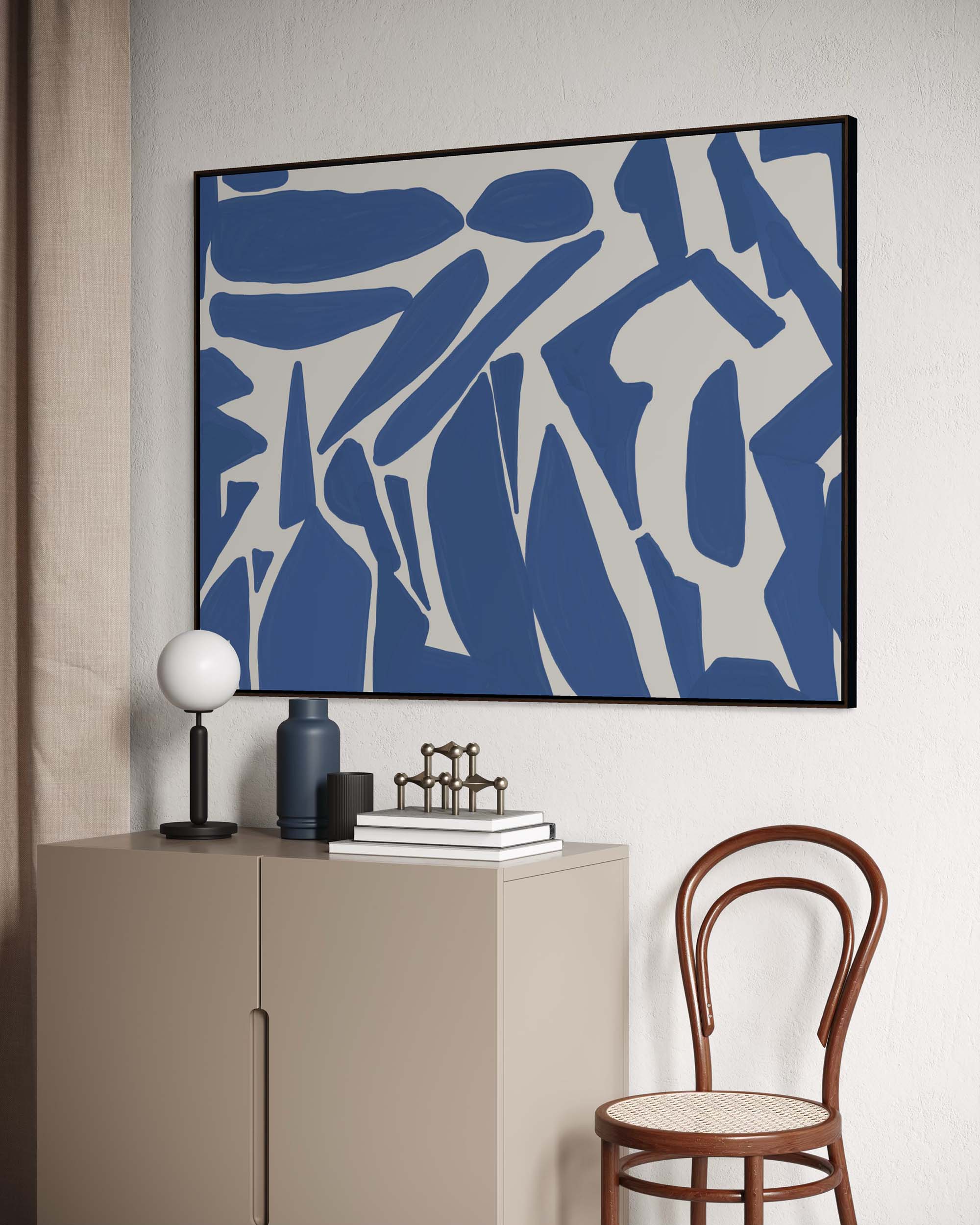 Abstract blue and white artwork on a wall above a cabinet with decor items.