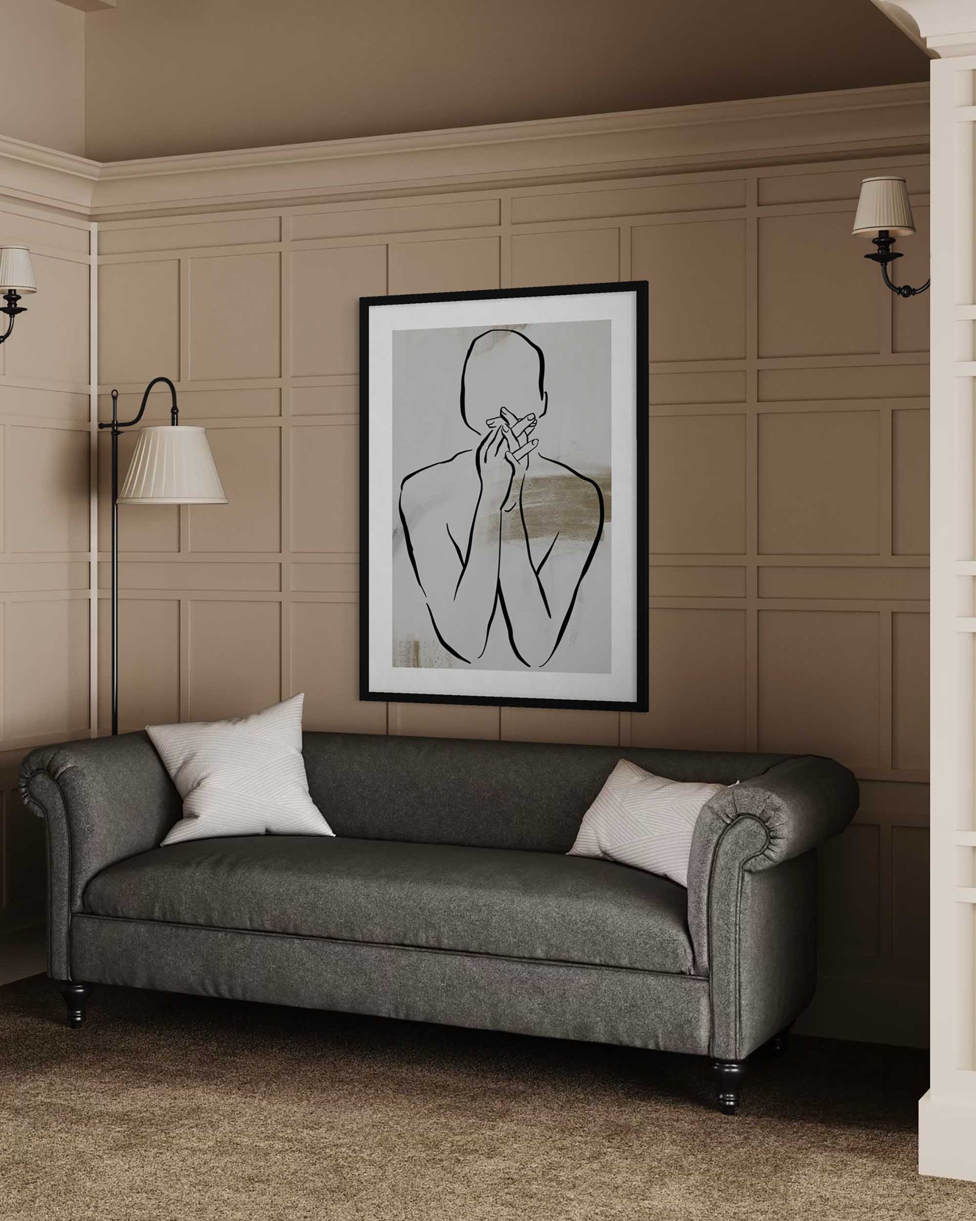 Gray sofa in a room with a framed black and white artwork on the wall.