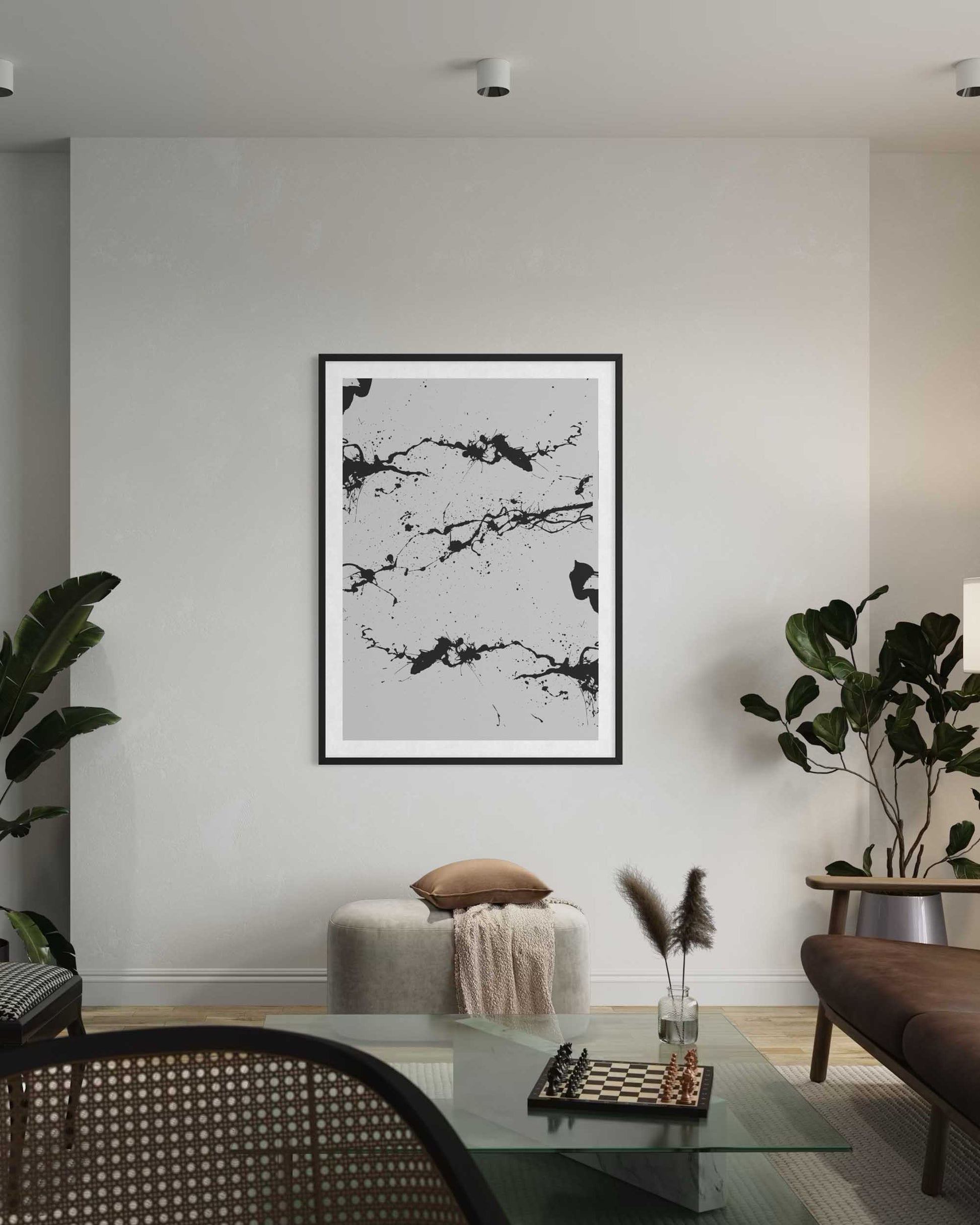 Modern living room with abstract art on the wall, glass coffee table, and chairs.