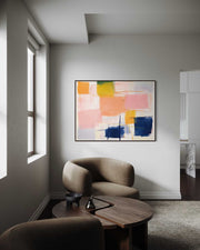 Modern living room with abstract art on the wall and a round wooden coffee table.