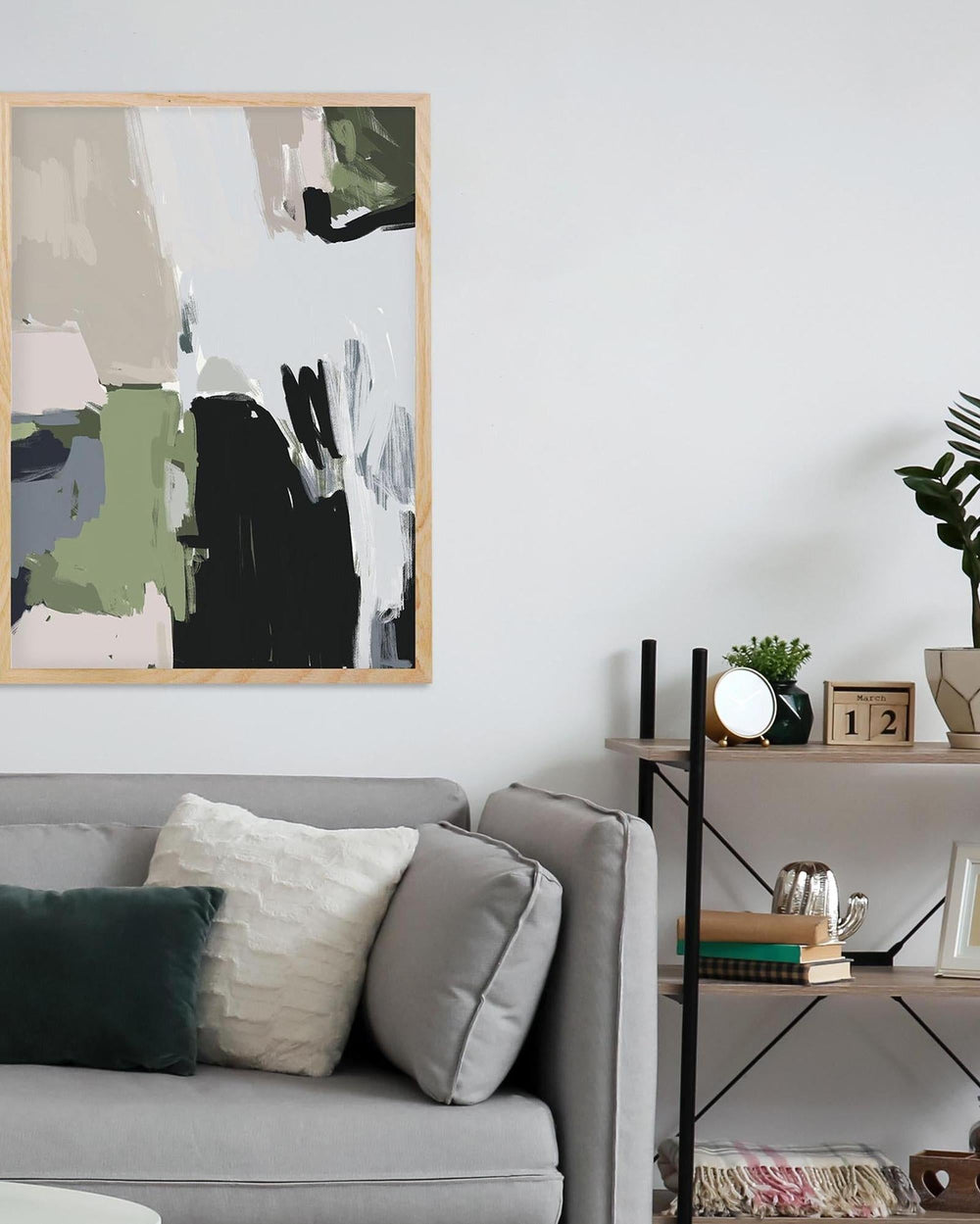 Living room with abstract art on the wall, gray sofa, and decorative items.