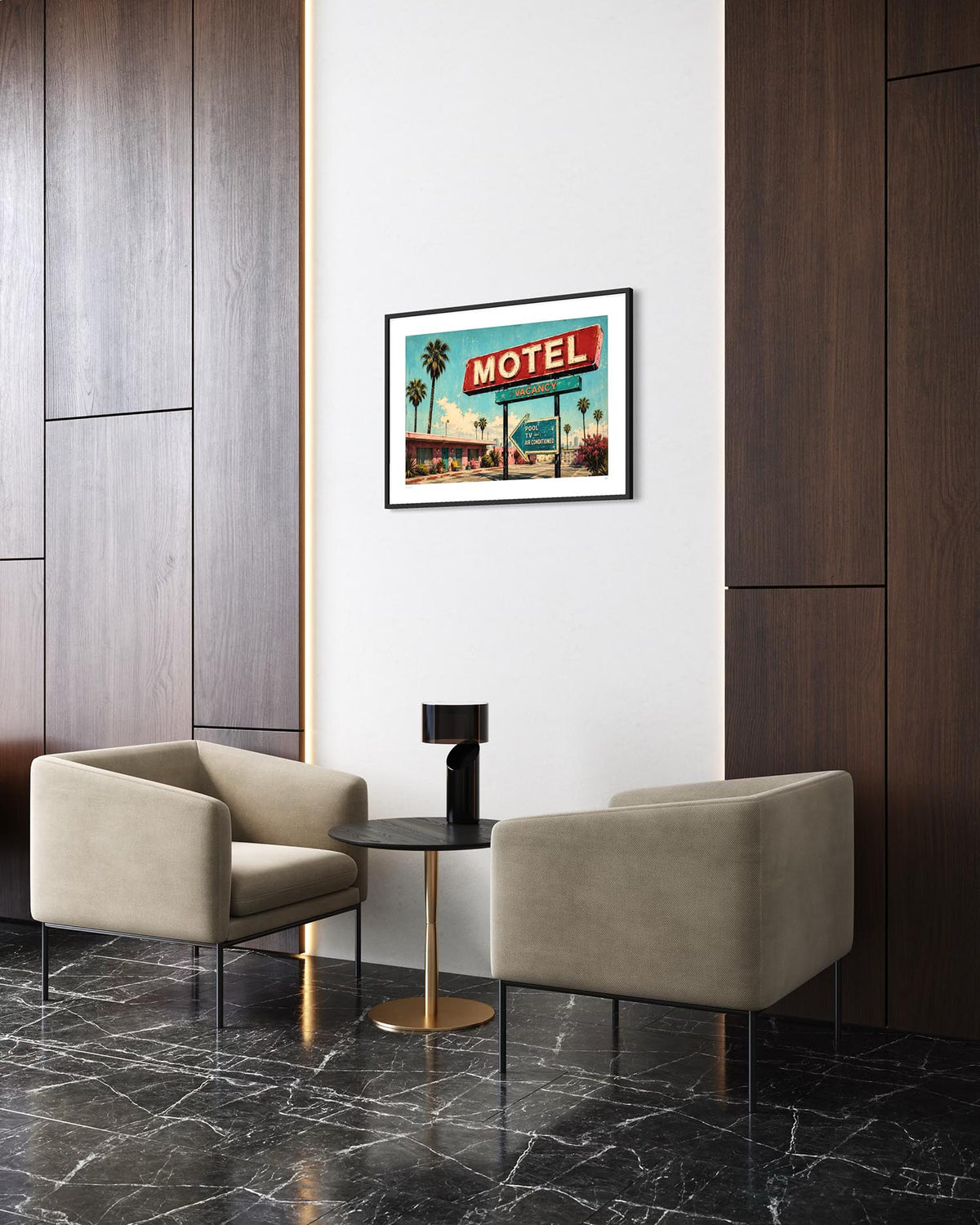 A framed retro-style 'Motel' art print hangs on a white wall in a modern interior setting with two beige armchairs, a small round table, and dark wood paneling.