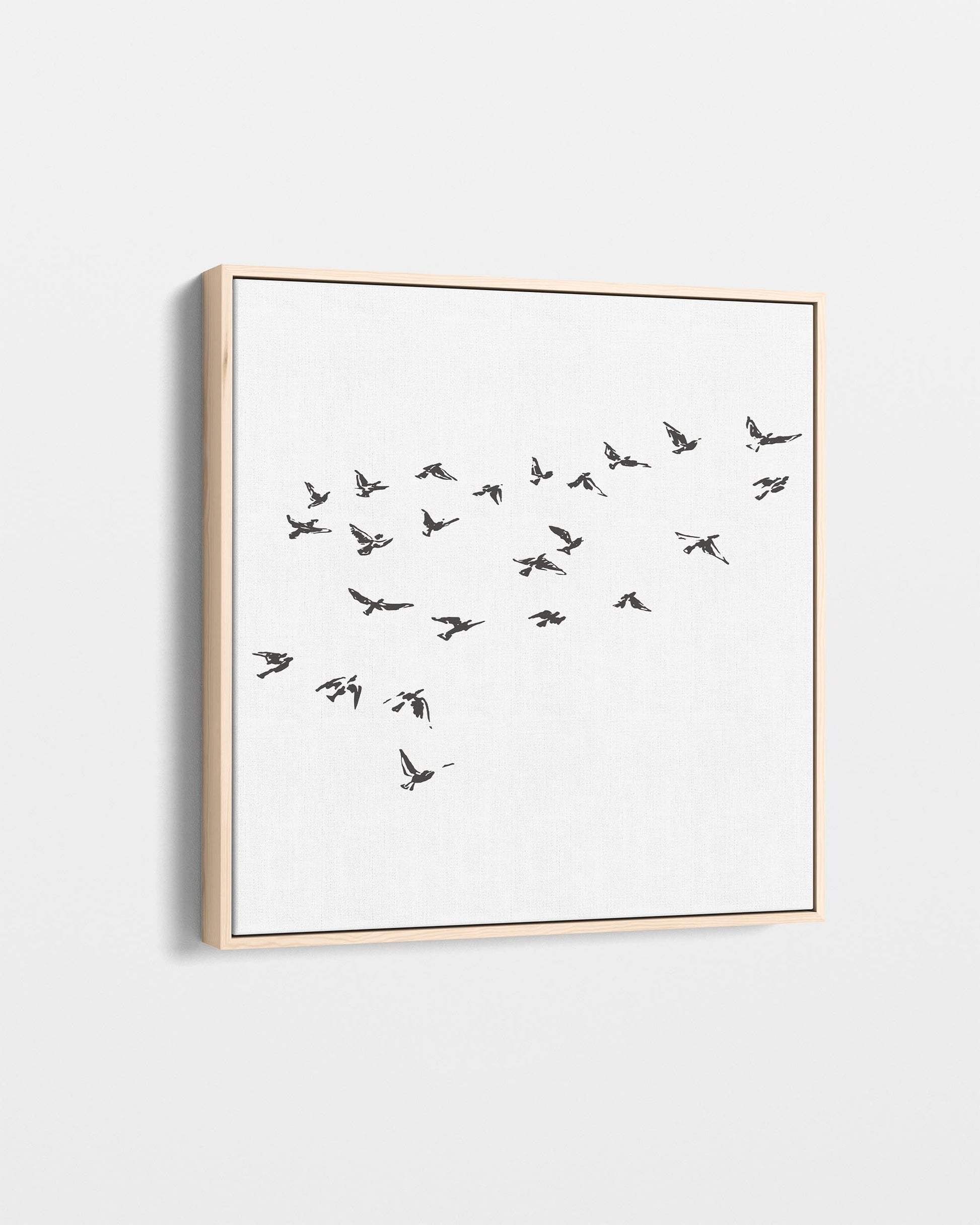 Framed artwork of birds in flight on a white background